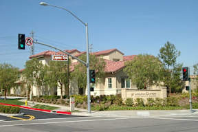 A street view of Laguna Canyon Estates with a traffic light showing green.