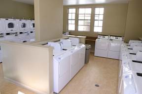 A room full of white washing machines.