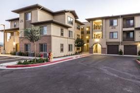 A large apartment complex with a red fire hydrant in front.