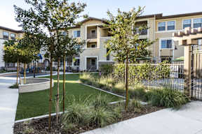 A modern apartment complex with a landscaped courtyard.