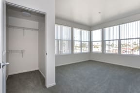 A large empty room with a doorway leading to another room.