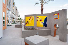 A concrete bench with a yellow painting on it.