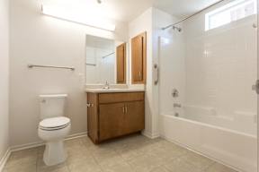 A white toilet sits next to a sink in a bathroom.