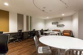 A conference room with a white table and chairs.