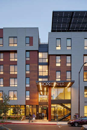 A modern building with the name "THE OPEN CENTER" on the front.