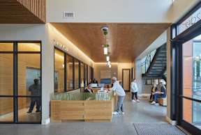 A lobby with people sitting and standing.