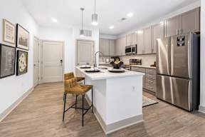 a kitchen with a large island and stainless steel appliances at Contrast OTR Apartments, Cincinnati, OH, 45202