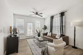a living room with a couch and a coffee table at Contrast OTR Apartments, Cincinnati, OH