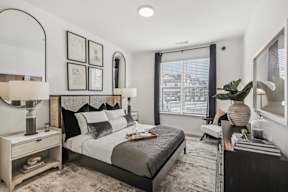 an apartment bedroom with a large bed and a window at Contrast OTR Apartments, Cincinnati, 45202