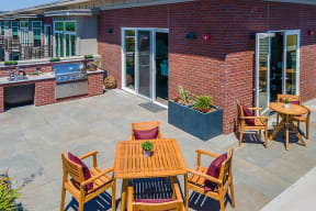 Apartment San Rafael CA - Second and B Street - Resident Lounge Balcony Overlooking the City with a Grill, Two Seating Areas with Tables and Chairs, and Decorative Plants