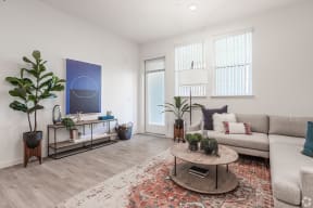 Apartments for Rent Livermore - Ageno - Furnished Living Room With Stylish Furniture, Wood Flooring, and Decorative House Plants