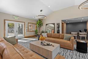 A Living Room With a Brown Leather Couch at ALTITUDE BY VINTAGE, Nevada