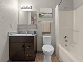 A bathroom with a toilet, sink, and bathtub at ALTITUDE BY VINTAGE, Reno