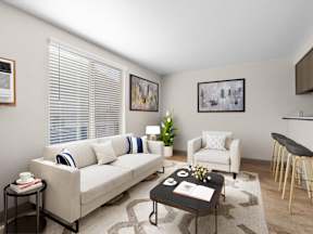 A living room with a white couch, a coffee table, and a rug at ALTITUDE BY VINTAGE, Reno, Nevada, 89523