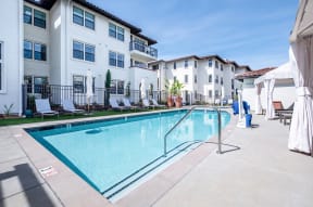 Livermore Apartments for Rent - Ageno - Outdoor Pool With Clear Water, Lounge Chairs, and Additional Covered Seating