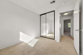 Bedroom with mirrored closet doors 