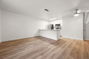 Wood floor in living room near kitchen