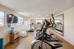 1 BR Apartments in Reno NV - Altitude by Vintage - Fitness-Center with Cardio Equipments, a Mirror, TV, and Windows