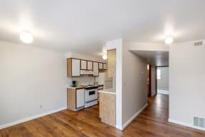 Kitchen with Tile Floors, Brown Cabinets, and White Kitchen Appliances at ALTITUDE BY VINTAGE, Reno Nevada