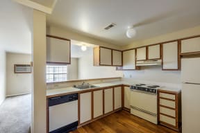 Studio Apartments in Reno NV - Southridge - Conventional Kitchen with White Cabinets and Wood-Style Flooring