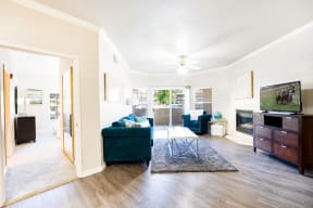 a living room with white walls and hardwood floors