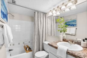 a bathroom with a sink toilet and bathtub at The Bentley at Maitland, ORLANDO Florida