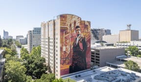 a large mural of a man in a suit on the side of a building