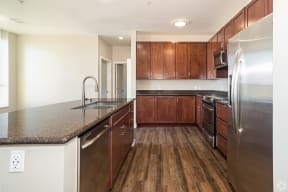 a kitchen with wood cabinets and granite countertops