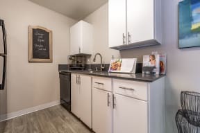 Renton Sage kitchen area with white cabinets