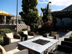 Spanish Springs NV Apartments - High Rock 5300 - Cozy Fire Pit with Comfortable Seating, Pool Views, and Greenery