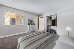 Two-Bedroom Apartments in Colton, CA - Ardella at Reche Canyon - Large Bedroom with Wall-to-Wall Carpeting, Spacious Closet with Sliding Doors, and a Large Window
