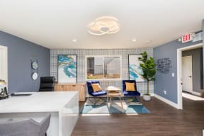 a room with blue walls and a white counter with two chairs and a table