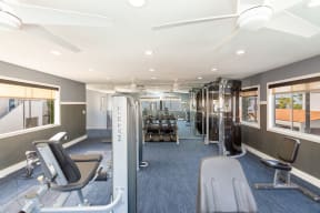 Apartments for Rent in Colton, CA - Ardella at Reche Canyon - Fitness Center with Weight Lifting Equipment, Training Machines, Large Windows, and Ceiling Fans