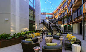 A patio with a staircase and a lot of seating.