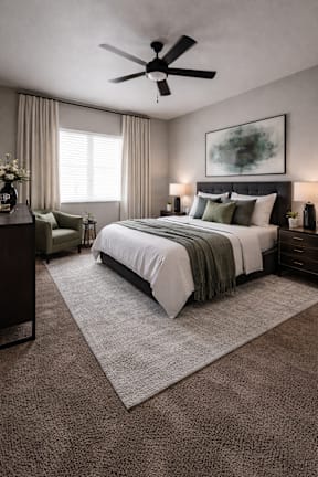 A bedroom with a large bed and a ceiling fan.