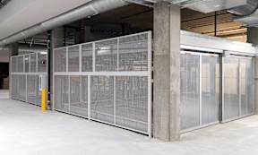 A large, empty room with a white floor and a glass partition wall.