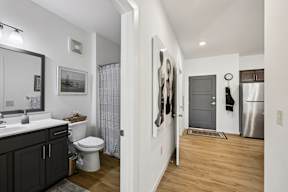 A bathroom with a toilet, sink, and a shower curtain.