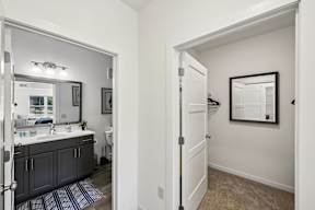 A bathroom with a sink, mirror, and toilet.