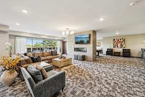 A living room with a grey sofa and a wooden coffee table.