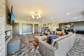 A living room with a grey couch and a television.