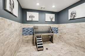 A bathroom with a walk-in shower and a bench.