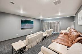 A row of brown leather chairs are lined up in a room.