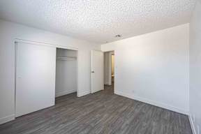 A room with a grey floor and white walls.
