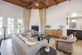 A living room with a grey sofa and a black coffee table.