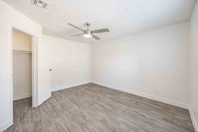 A room with a ceiling fan and light fixture.