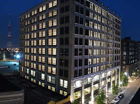 a tall building with many windows at night