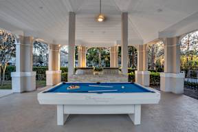 A pool table with Disney Internships written on it.