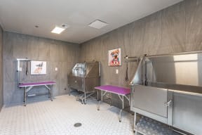 a room with two silver machines and two pink benches