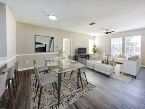 A modern dining room with a glass table and chairs.