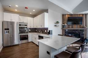 A modern kitchen with a large island and stainless steel appliances.